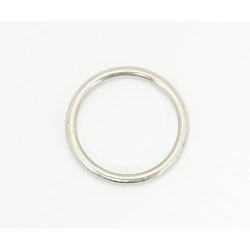 607 - A white metal ring, marked 'platinum'. Ring size approx. J