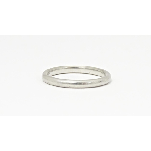 607 - A white metal ring, marked 'platinum'. Ring size approx. J