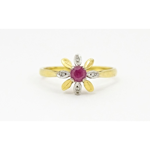 608 - An 18ct gold ring set with a central ruby bordered by chip set diamonds in a floral setting. Ring si... 