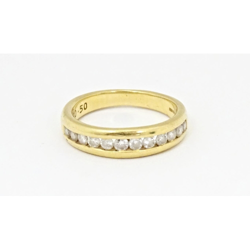 610 - An 18ct gold half eternity ring with channel set diamonds. Ring size approx. L 1/2