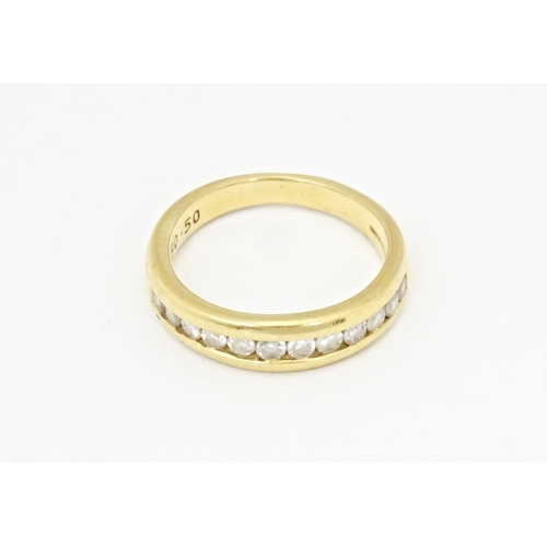 610 - An 18ct gold half eternity ring with channel set diamonds. Ring size approx. L 1/2