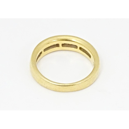 610 - An 18ct gold half eternity ring with channel set diamonds. Ring size approx. L 1/2