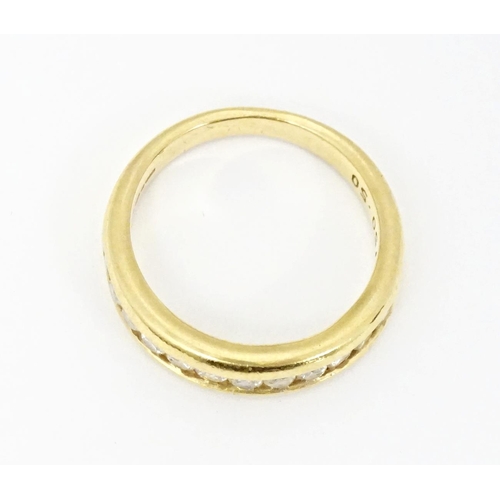 610 - An 18ct gold half eternity ring with channel set diamonds. Ring size approx. L 1/2