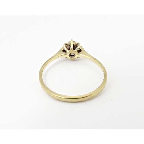 613 - A 9ct gold ring set with four diamonds. Ring size approx. L