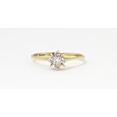 613 - A 9ct gold ring set with four diamonds. Ring size approx. L