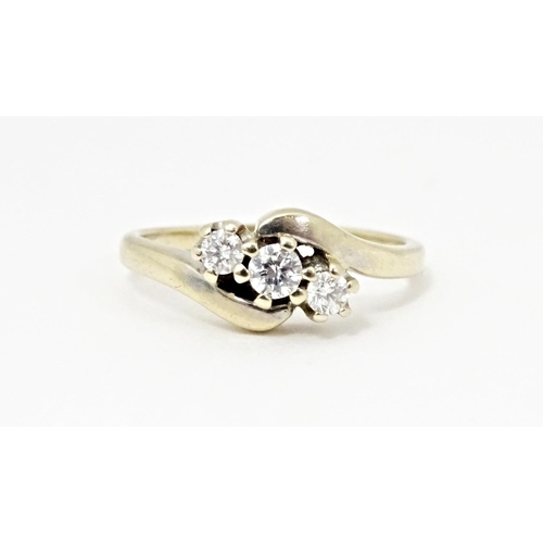 616 - An 18ct gold ring set with three diamonds. Ring size approx. L