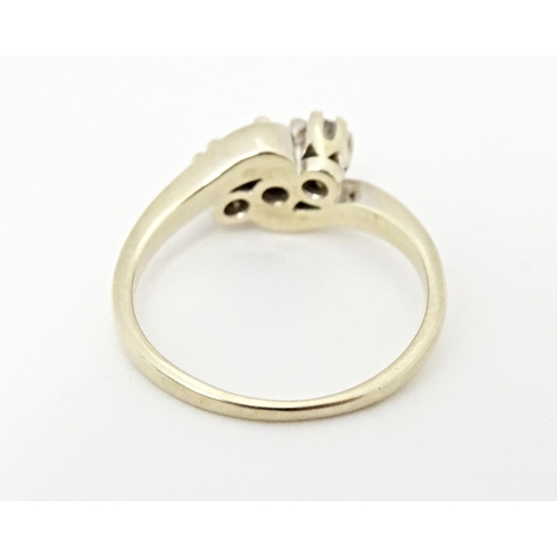 616 - An 18ct gold ring set with three diamonds. Ring size approx. L