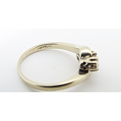 616 - An 18ct gold ring set with three diamonds. Ring size approx. L