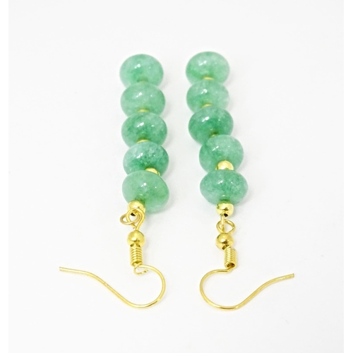 704 - A pair of gilt metal drop earrings set with green beads. Approx 2