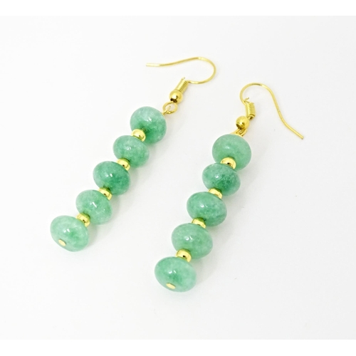 704 - A pair of gilt metal drop earrings set with green beads. Approx 2