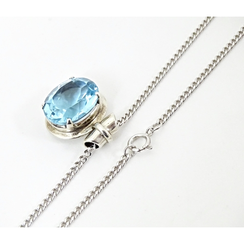 707 - A. 925 silver pendant and chain, the pendant set with topaz. The pendant  3/4