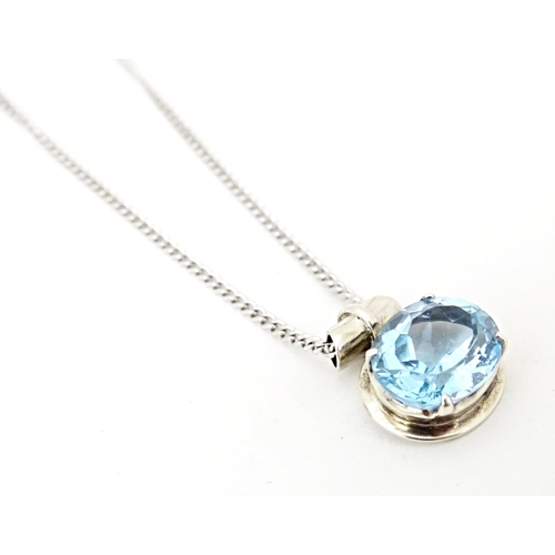 707 - A. 925 silver pendant and chain, the pendant set with topaz. The pendant  3/4