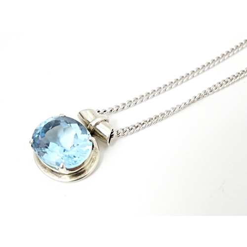 707 - A. 925 silver pendant and chain, the pendant set with topaz. The pendant  3/4