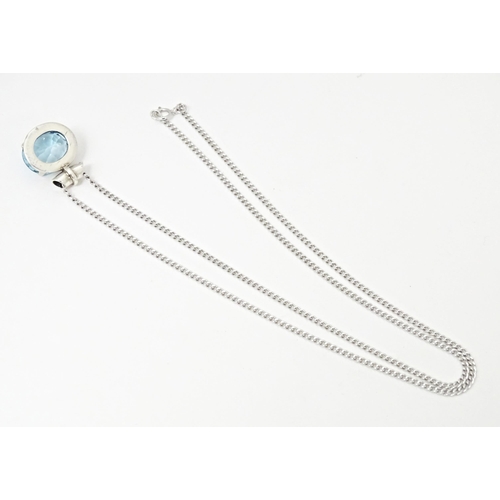 707 - A. 925 silver pendant and chain, the pendant set with topaz. The pendant  3/4