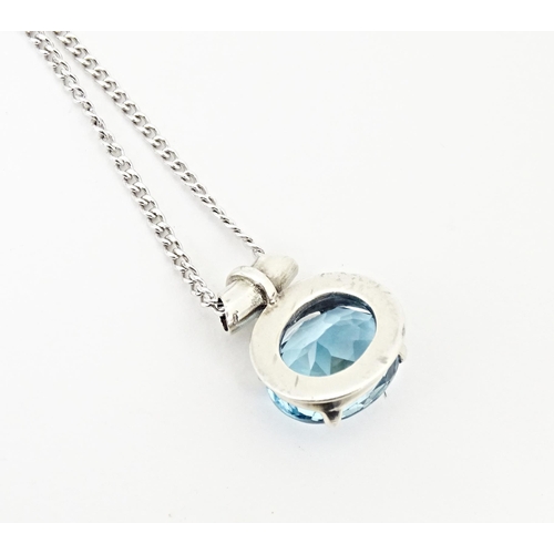 707 - A. 925 silver pendant and chain, the pendant set with topaz. The pendant  3/4