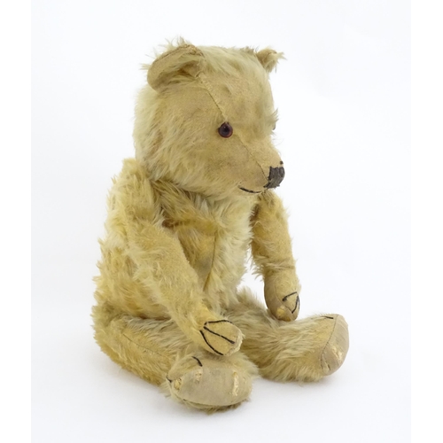 823 - Toy: A 20thC mohair teddy bear with stitched nose, mouth and paws. Approx. 19 1/2