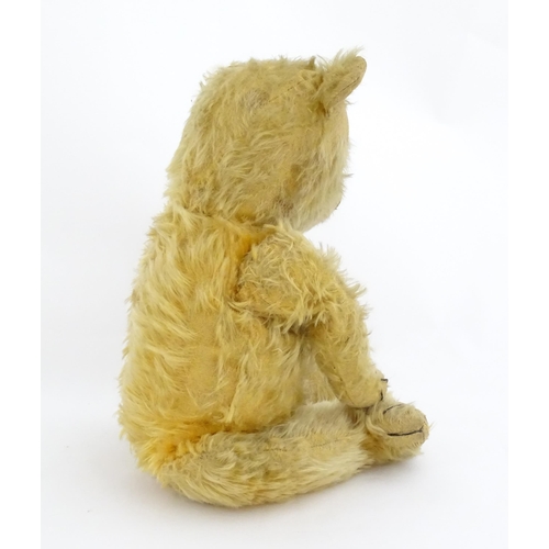 823 - Toy: A 20thC mohair teddy bear with stitched nose, mouth and paws. Approx. 19 1/2