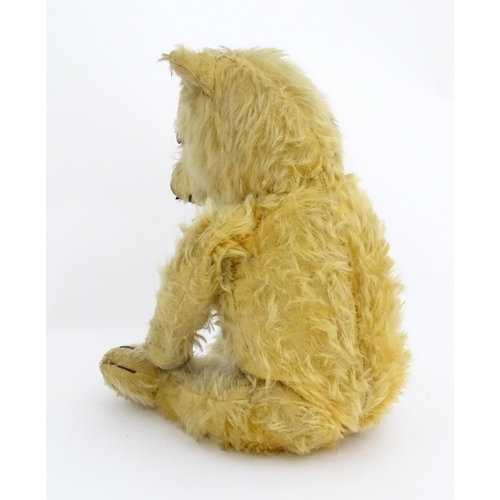 823 - Toy: A 20thC mohair teddy bear with stitched nose, mouth and paws. Approx. 19 1/2