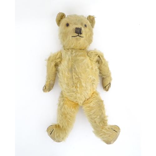 823 - Toy: A 20thC mohair teddy bear with stitched nose, mouth and paws. Approx. 19 1/2