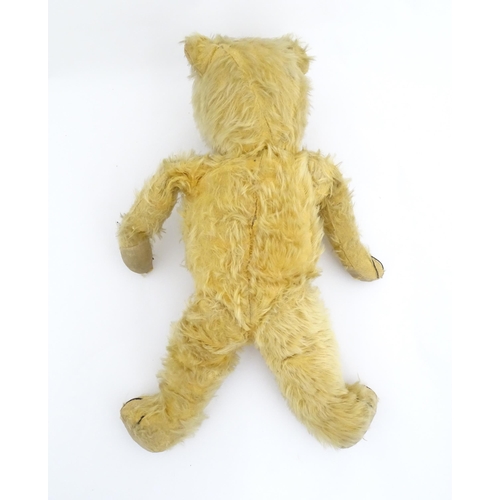 823 - Toy: A 20thC mohair teddy bear with stitched nose, mouth and paws. Approx. 19 1/2