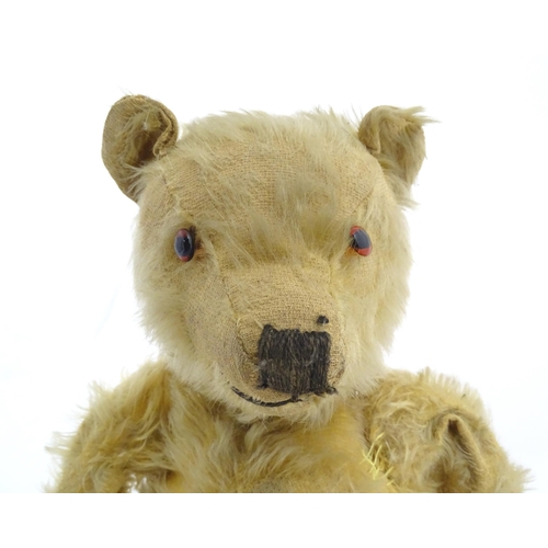 823 - Toy: A 20thC mohair teddy bear with stitched nose, mouth and paws. Approx. 19 1/2