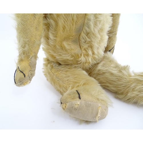 823 - Toy: A 20thC mohair teddy bear with stitched nose, mouth and paws. Approx. 19 1/2