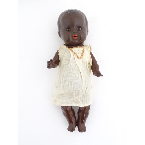 831 - Toy: A 20thC Hermann Steiner black doll with a composite head and body, with articulated arms and le... 