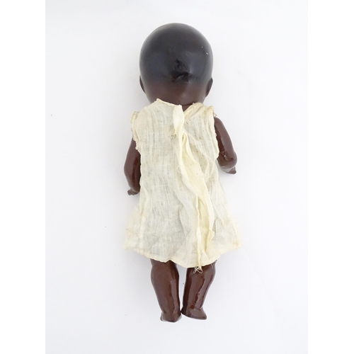 831 - Toy: A 20thC Hermann Steiner black doll with a composite head and body, with articulated arms and le... 