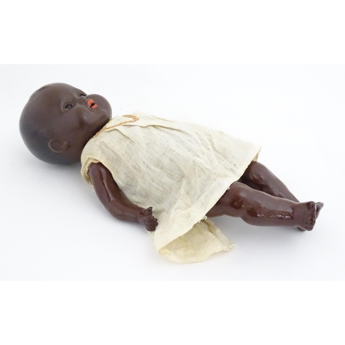 831 - Toy: A 20thC Hermann Steiner black doll with a composite head and body, with articulated arms and le... 