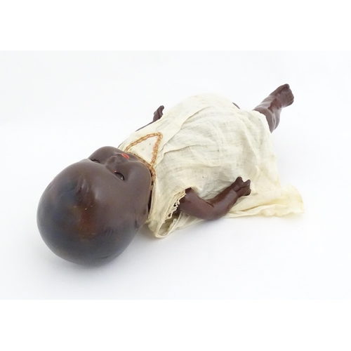 831 - Toy: A 20thC Hermann Steiner black doll with a composite head and body, with articulated arms and le... 