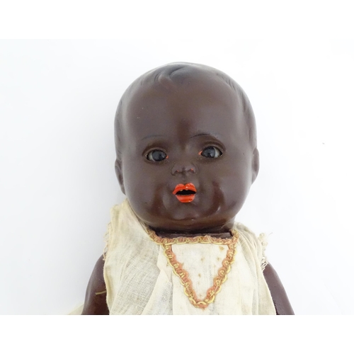 831 - Toy: A 20thC Hermann Steiner black doll with a composite head and body, with articulated arms and le... 