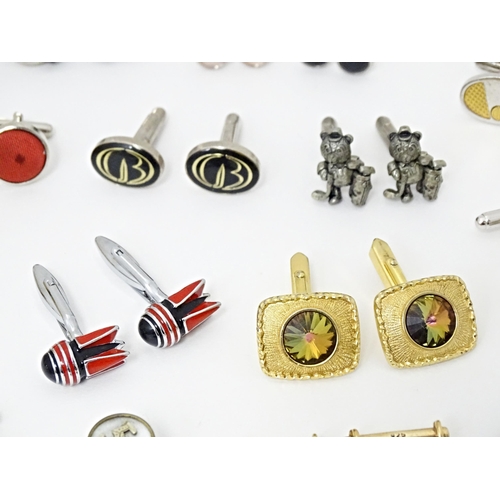 711 - A quantity of assorted cufflinks, studs, a tie clip by Dunhill, etc. Together with an ivorine box wi... 