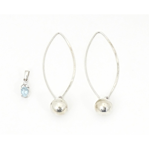 715 - A pair of white metal drop earrings. Together with white metal pendant set with pale blue and white ... 