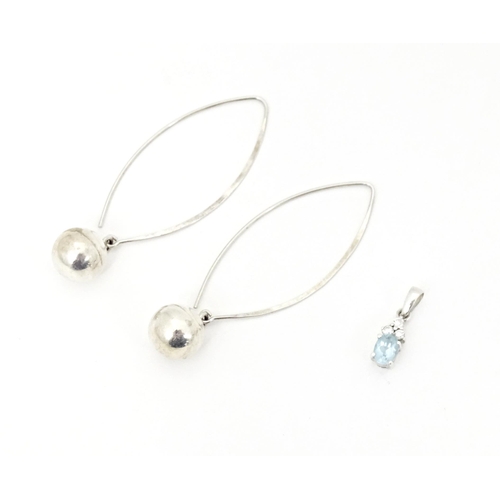 715 - A pair of white metal drop earrings. Together with white metal pendant set with pale blue and white ... 