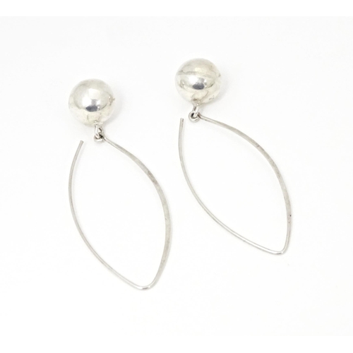 715 - A pair of white metal drop earrings. Together with white metal pendant set with pale blue and white ... 