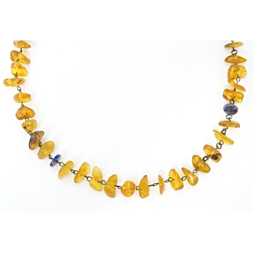 717 - Three various amber coloured bead necklaces. The longest also set with lapis lazuli beads. Approx 20... 