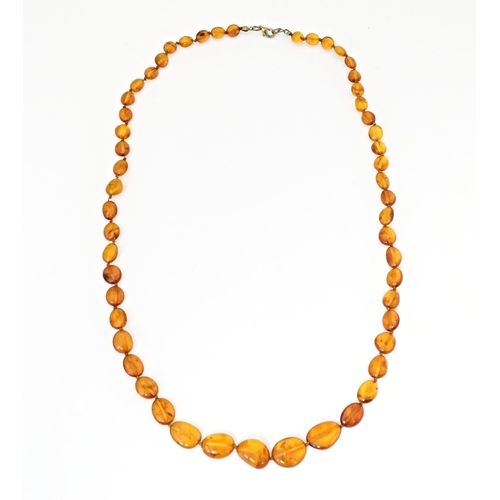 717 - Three various amber coloured bead necklaces. The longest also set with lapis lazuli beads. Approx 20... 