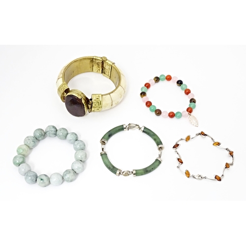 718 - Five assorted bracelets to include jade coloured bead bracelets, silver and amber bracelet etc (5)