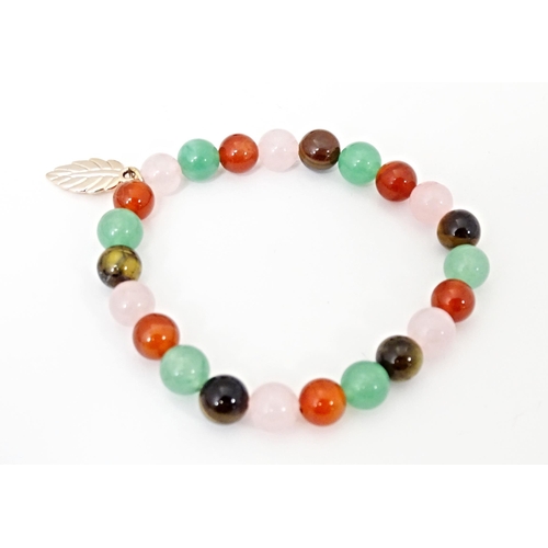 718 - Five assorted bracelets to include jade coloured bead bracelets, silver and amber bracelet etc (5)