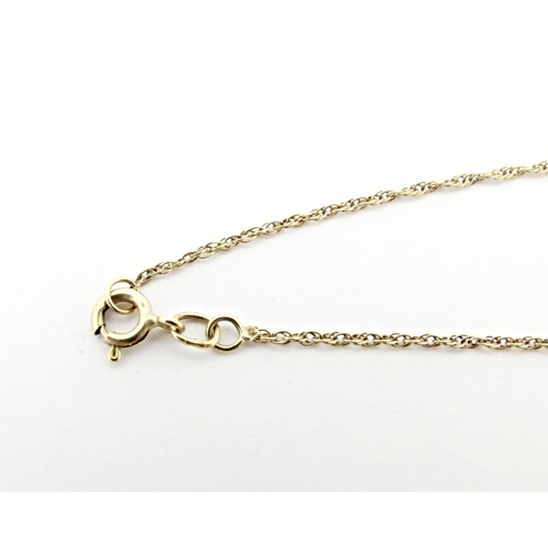 720 - A 9ct gold pendant of heart form set with central diamond, on a gold chain necklace approx 16