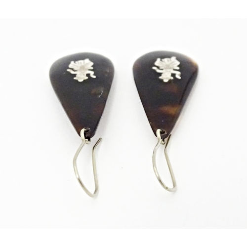 729 - A pair of tortoiseshell drop earrings. Approx 1 1/2