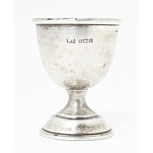 406 - A silver egg cup of pedestal form, hallmarked Birmingham 1959, maker William Adams Ltd. Approx. 2 1/... 