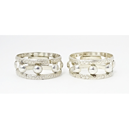 409 - A pair of South African silver napkin rings, by Joe Calafato. Marked Ster. Silv Candida (2)