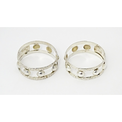 409 - A pair of South African silver napkin rings, by Joe Calafato. Marked Ster. Silv Candida (2)