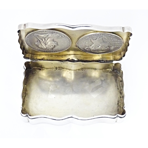 411 - A silver box of shaped form, the lid inset with two inlaid Victorian medallions, hallmarked Birmingh... 