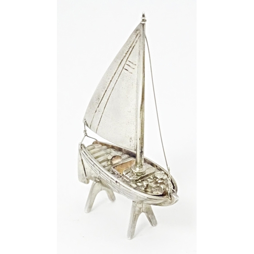 414 - A silver model of a sailing boat. Approx. 2 1/2