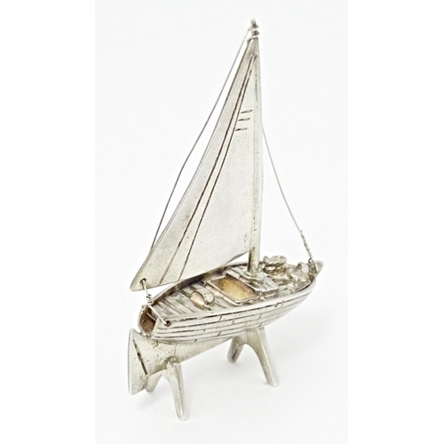 414 - A silver model of a sailing boat. Approx. 2 1/2