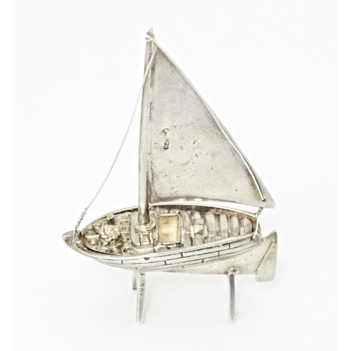 414 - A silver model of a sailing boat. Approx. 2 1/2