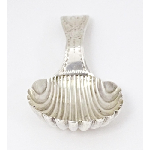 415 - A silver caddy spoon with shell formed bowl and bright cut decoration to handle, hallmarked London 1... 