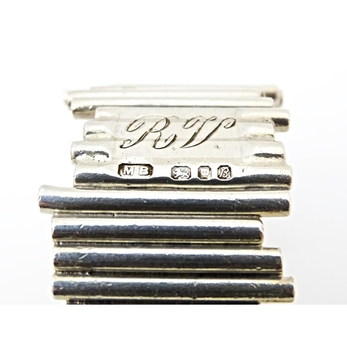 416 - An Elizabeth II silver napkin ring of modernist form, hallmarked London 1976, maker M. B.